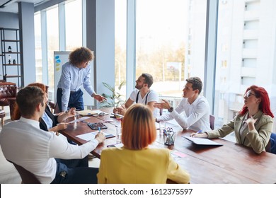 Instructions by young leader of company, leading, progress concept. Leading people of company gathered to discuss issues on the agenda - Shutterstock ID 1612375597