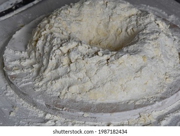 Instructions For Making A Puff Napoleon Cake At Home. Step Three: Knead The Dough, Make A Circle With A Funnel Inside For Pouring Cold Water