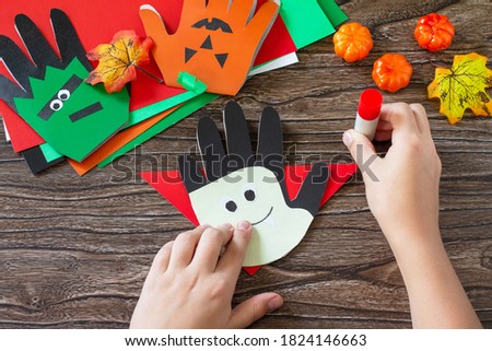 Instructions, step 16. Greeting card halloween on wooden table. Children's creativity project, crafts, crafts for kids.