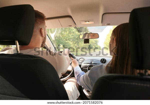 Instructor conducting\
driver licence test