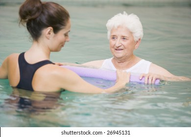 Instructor And Elderly Patient Undergoing Water Therapy