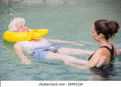 Instructor And Elderly Patient Undergoing Water Therapy