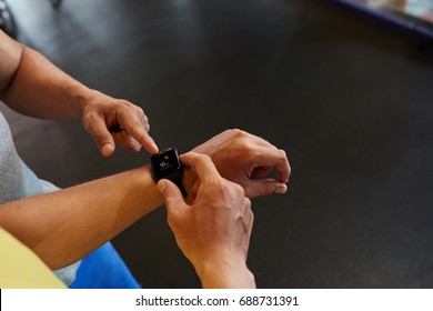 Instructor explaining information on smart watch to client - Shutterstock ID 688731391