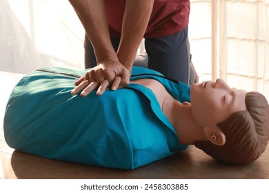 instructor guides an adult in CPR training, importance of first aid emergency medicine. careful compression on a CPR dummy chest, practice life-saving skills, preparing for accidents and disasters. - Powered by Shutterstock