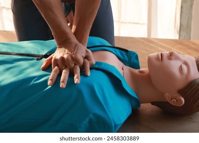 instructor guides an adult in CPR training, importance of first aid emergency medicine. careful compression on a CPR dummy chest, practice life-saving skills, preparing for accidents and disasters. - Powered by Shutterstock