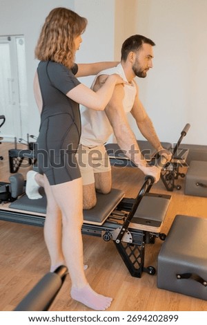 Instructor guides posture correction, Calm atmosphere with handson guidance for posture improvement