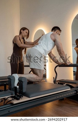Instructor guides posture correction, Calm atmosphere with handson guidance for posture improvement