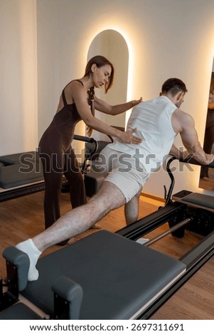 Instructor guides posture correction, Calm atmosphere with handson guidance for posture improvement