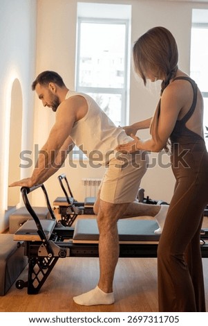 Instructor guides posture correction, Calm atmosphere with handson guidance for posture improvement