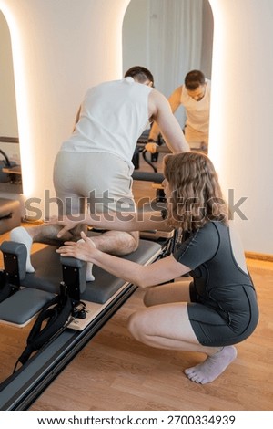 Instructor guides posture correction, Calm atmosphere with handson guidance for posture improvement