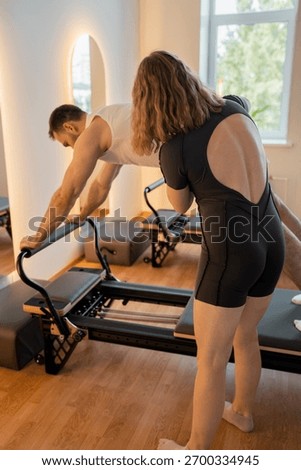 Instructor guides posture correction, Calm atmosphere with handson guidance for posture improvement