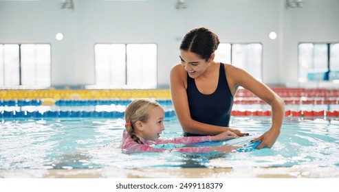 Instructor, helping and child in pool, swimming or woman with smile, proud or teaching girl in water. Bathing suit, happy or learning with teacher in school for training of kid, sports or competition - Powered by Shutterstock