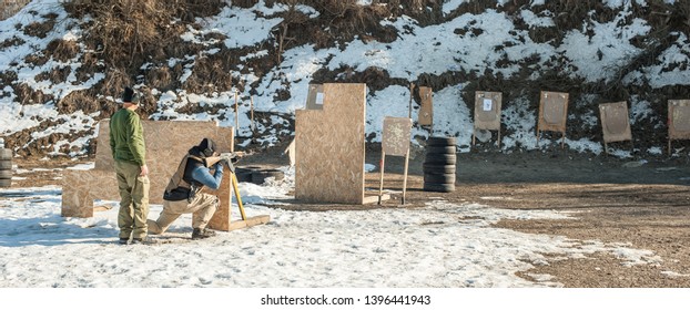 Instructor and his student had rifle machine gun shooting training on outdoor shooting range. Winter and snow cold season