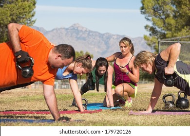 Instructor Holding Stopwatch While Teaching Bootcamp Fitness