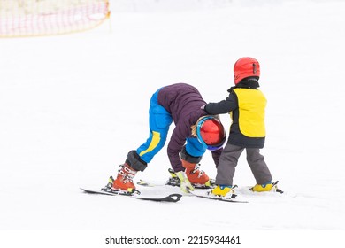 Instructor and little child skiing. toddler kid with safety helmet. Ski lesson for young children. Winter sport. Little skier