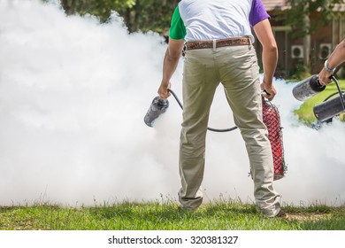 Instructor showing how to use a fire extinguisher on a training fire