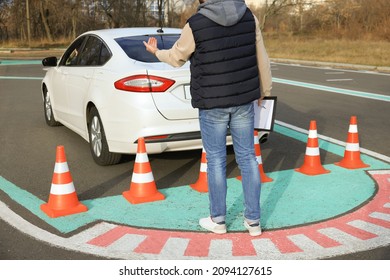 Instructor And Student In Car During Exam On Test Track. Driving School