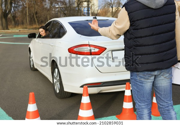 Instructor and student in car during exam on test\
track. Driving\
school