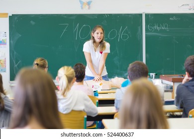 Instructor teaching first aid cardiopulmonary resuscitation course and use of automated external defibrillator workshop in primary school class. - Shutterstock ID 524400637