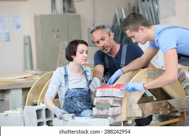 Instructor Teaching Teenagers Brick Laying