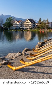 Instrument Alphorn Or Alpenhorn Or Alpine Horn Is A Labrophone, Consisting Of A Straight Several Meter Long Wooden Horn And Wooden Cup Shaped Mouthpiece.