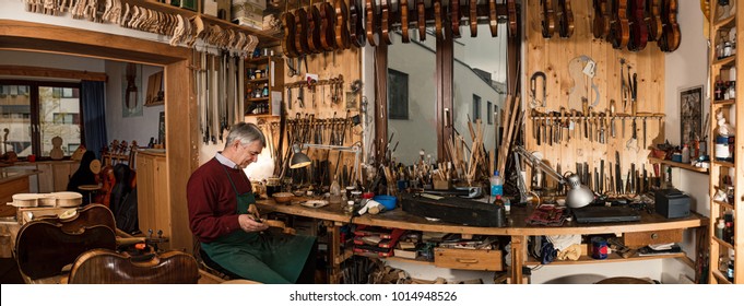 Instrument Maker Making Violin In His Workshop