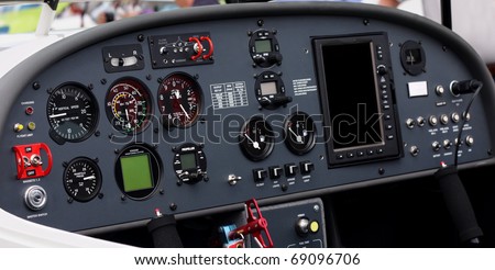 Instrument panel of a small airplane. Focus is on the left half of the image. The altitude and airspeed dials are easily readable at full size.