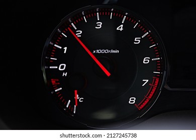 Instrument panel with tachometer and fuel level temperature engine, Close up image of illuminated car dashboard. Red arrow 