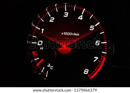 Instrument panel with tachometer and fuel level temperature engine, Close up image of illuminated car dashboard. Red arrow moving