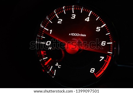 Instrument panel with tachometer and fuel level temperature engine, Close up image of illuminated car dashboard. Red arrow moving