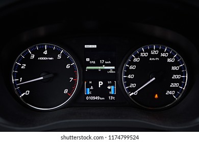 Instrument panel with tachometer and speedometer. Close up image of illuminated car dashboard.