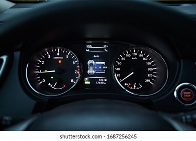 Instrument panel with tachometer and speedometer. Close up image of illuminated car dashboard.