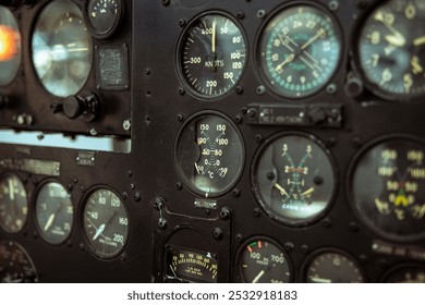 Instrument Panel of a Vintage Aircraft Cockpit. A close-up of a vintage aircraft cockpit instrument panel, featuring multiple dials and gauges. - Powered by Shutterstock