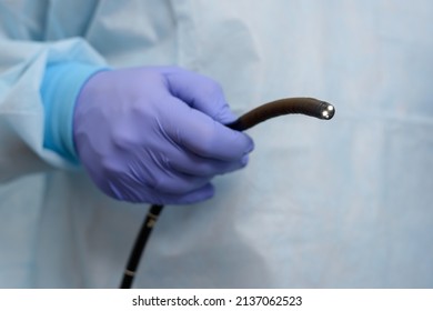 Instruments for diagnostic endoscopy close-up. The doctor holds a flexible endoscope in his hands. The process of gastroscopy, bronchoscopy or colonoscopy. Diagnostic and minimally invasive surgery.