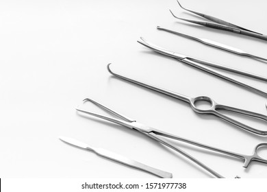 Instruments for plastic surgery on white background flat lay pattern copy space
