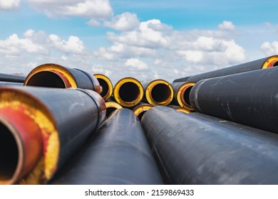 Insulated pipe. Large metal pipes with a plastic sheath at a construction site. Modern pipeline for supplying hot water and heating to a residential area
