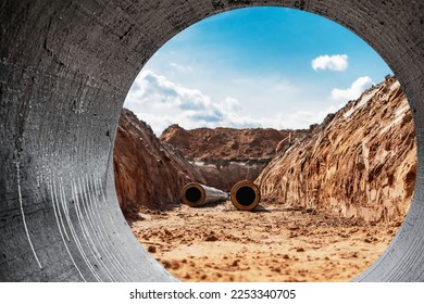 Insulated pipe. Large metal pipes with a plastic sheath laid in a trench. Modern pipeline for supplying hot water and heating to a residential area - Shutterstock ID 2253340705