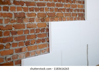   insulation of a brick wall with polystyrene white                             