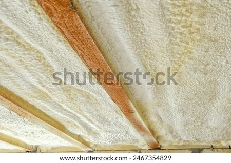 Insulation of the ceiling in the house with polyurethane foam. Insulating foam between wooden beams