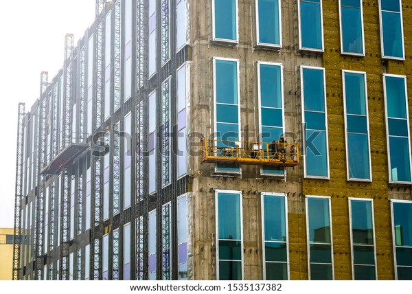 Insulation, glazing and cladding of the facade of
the building. Construction
site.