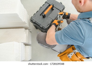 Insulation Installer Looking Through Toolbox To Find Bolts Fasteners And Nuts Needed For Job.