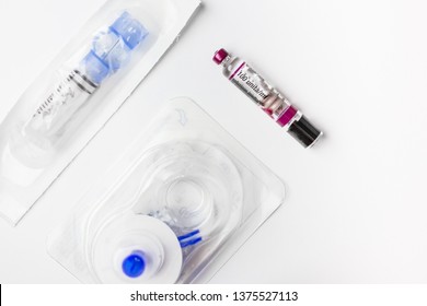 Insulin Ampoule And Continuous Glucose Monitor (CGM) Equipment Isolated On White Background. Health Protection, Diabetes, Low Blood Glucose Concept