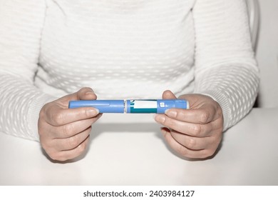 Insulin injection pen or insulin cartridge pen for diabetics. Medical equipment for diabetes parients. Woman holding an injection pen for diabetic. - Powered by Shutterstock