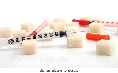 Insulin syringes with refined sugar around on the white background - Powered by Shutterstock