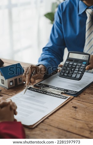 Insurance agent, Asian businessman handing a calculator to the customer to see the transaction price. The amount of the deposit or leasing to make investment decisions, the concept of bank loans.