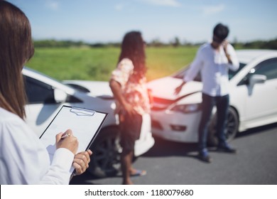 Insurance agent examine damaged car and customer filing signature on report claim form process after accident, Traffic accident and insurance concept.