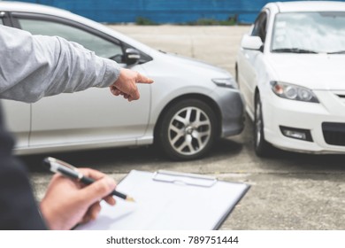 Insurance Agent Examine Damaged Car And Filing Report Claim Form After Accident, Traffic Accident And Insurance Concept.