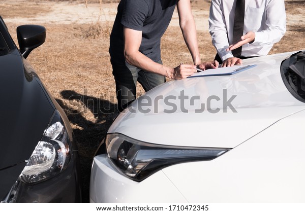 Insurance agent giving the
car owner is sign the agreement for accident claim, Car insurance
concept.