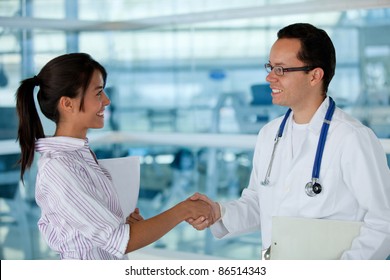 Insurance agent handshaking with a doctor making business