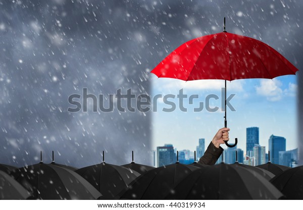 Insurance\
agent holding red umbrella to protect the life, health, savings,\
investment and accident, Insurance\
concept.